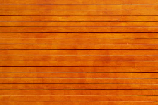 Close-up of a vibrant orange wooden wall texture, ideal for backgrounds.